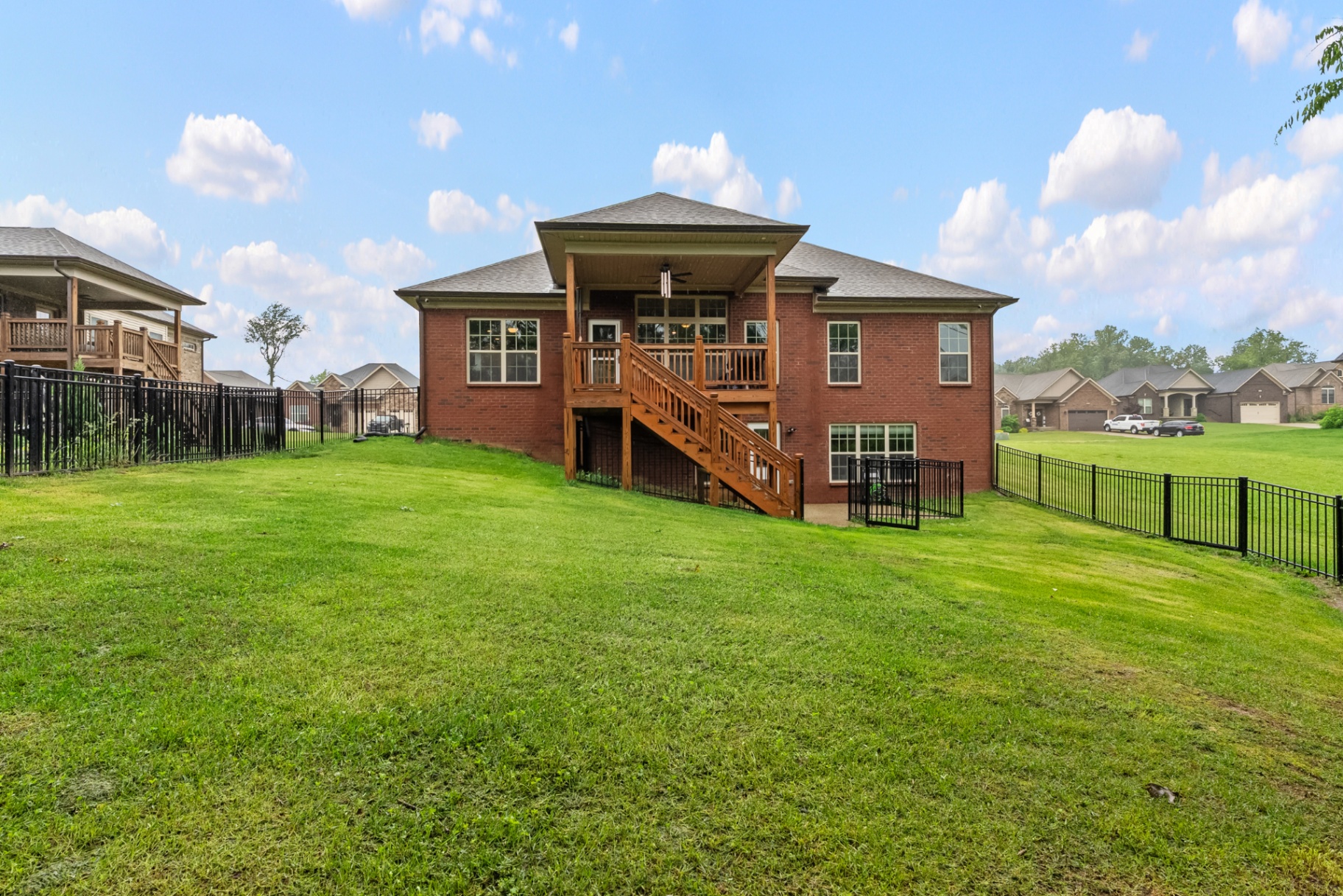 Rear exterior with covered deck and yard