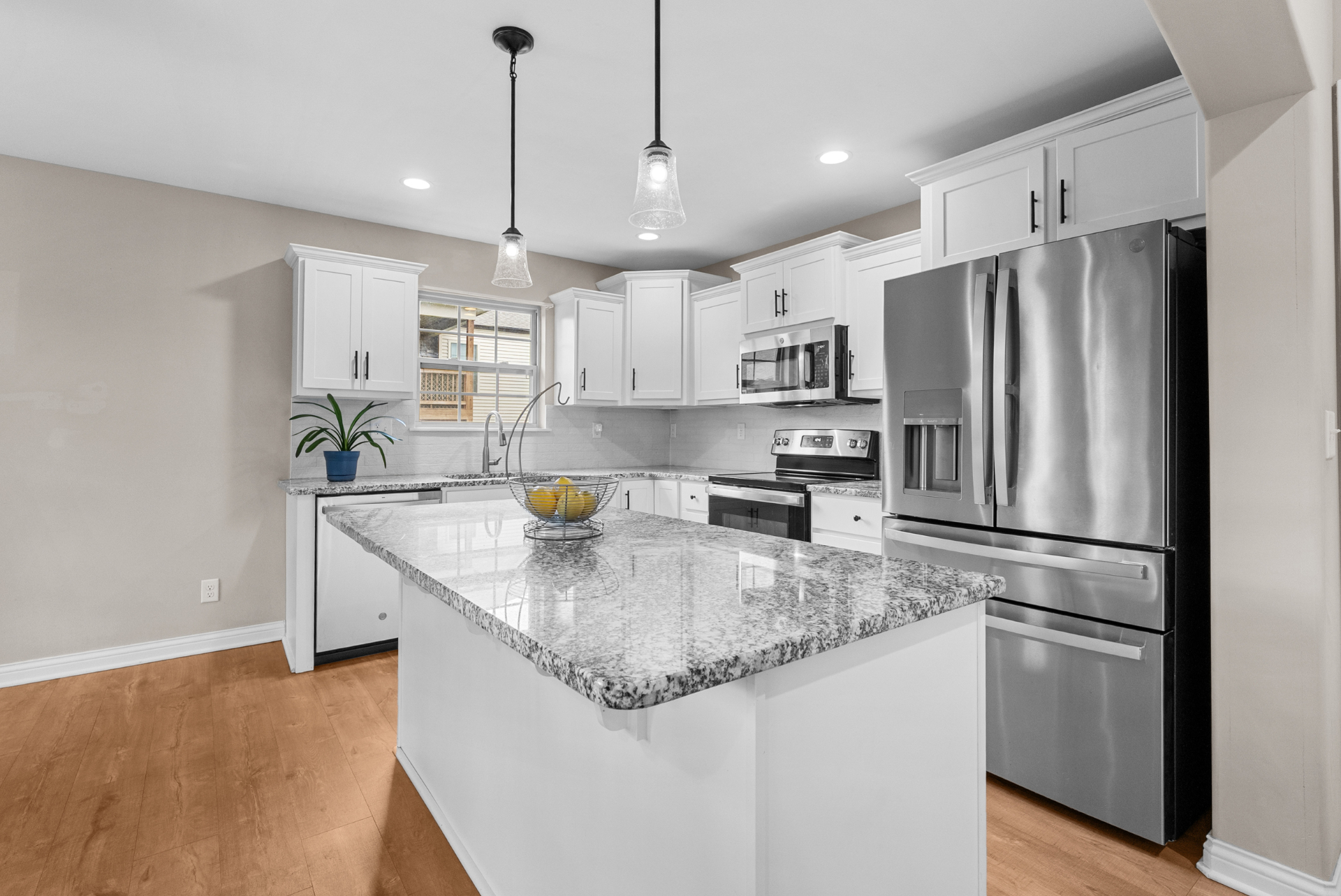 Kitchen island with granite and pendant lighting