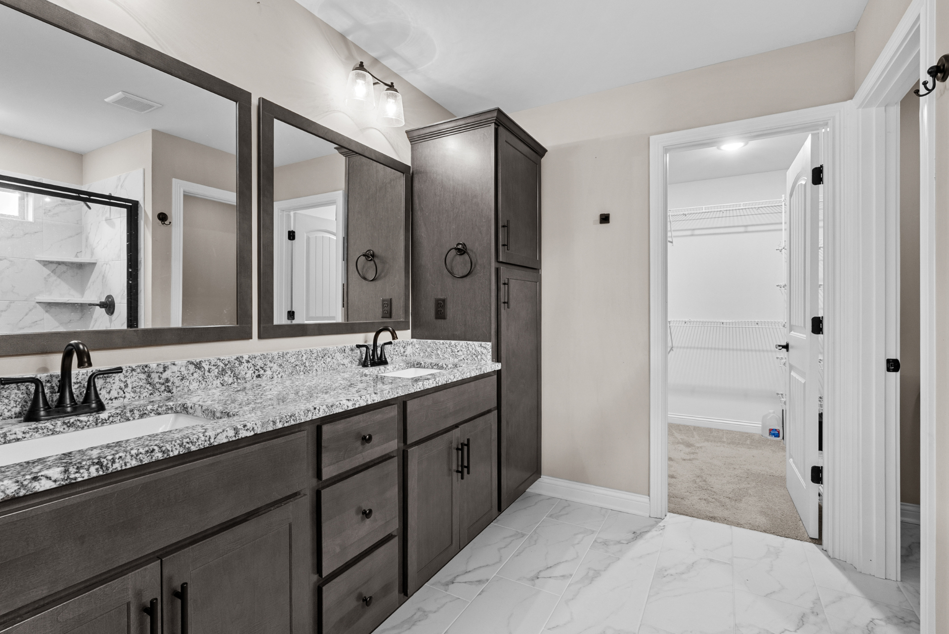 Primary bath with double vanity and walk-in closet